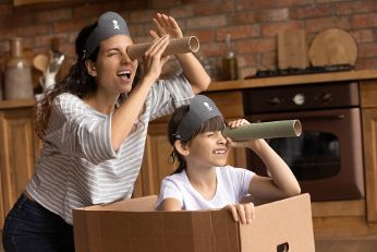 Woman and boy are playing pirates together.