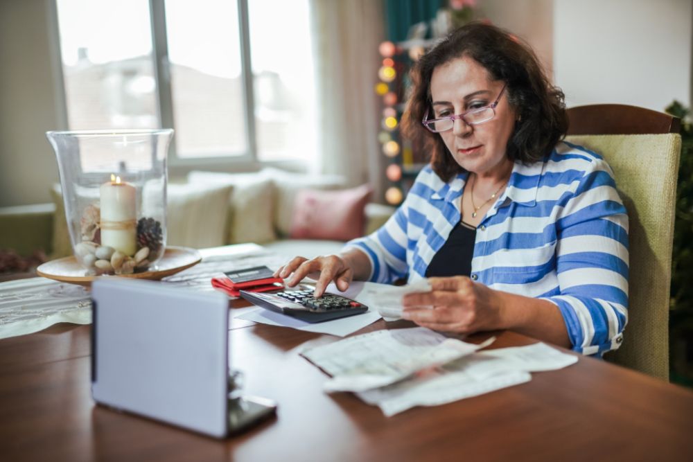 Frau rechnet mit Taschenrechner