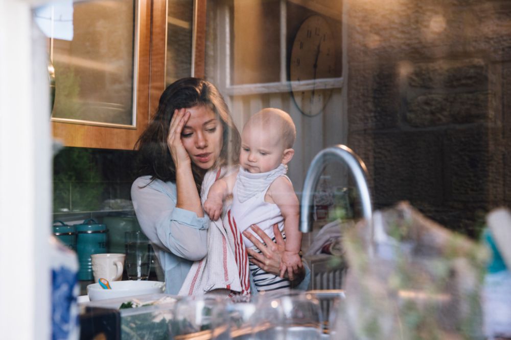 Woman with child near the sink