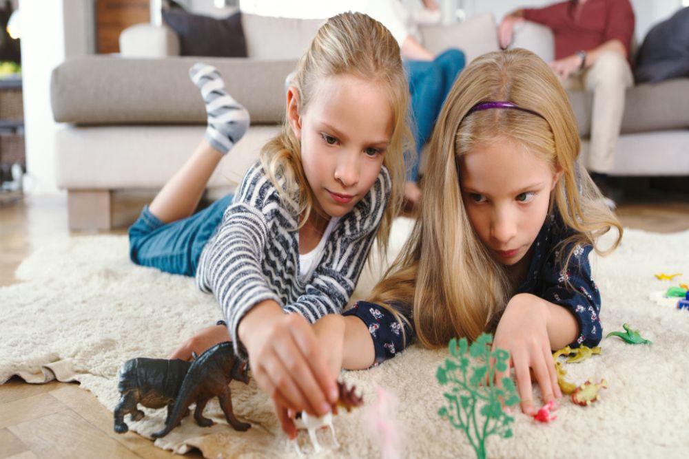 Twins playing on the ground