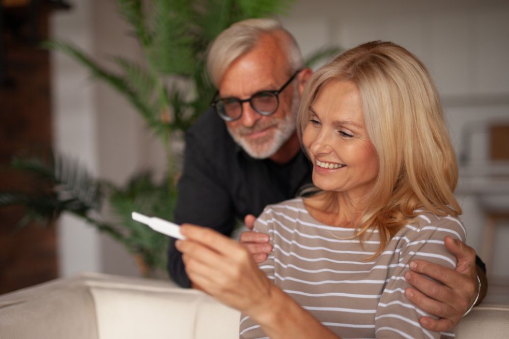 Elderly couple is looking at a positive pregnancy-test.