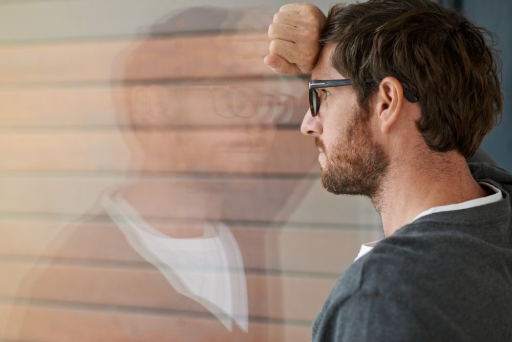 Man desperately lokking out of window