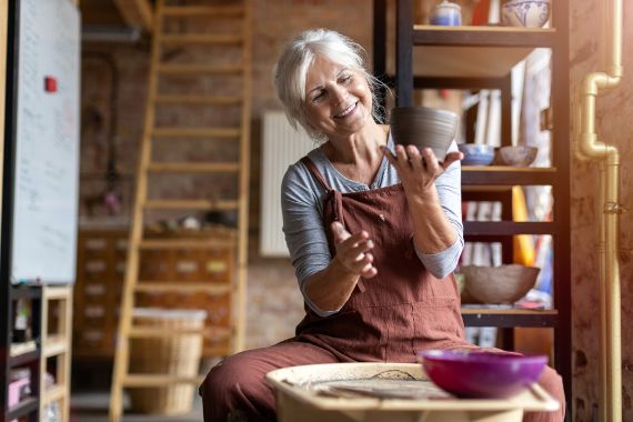 Elderly woman working on pottery