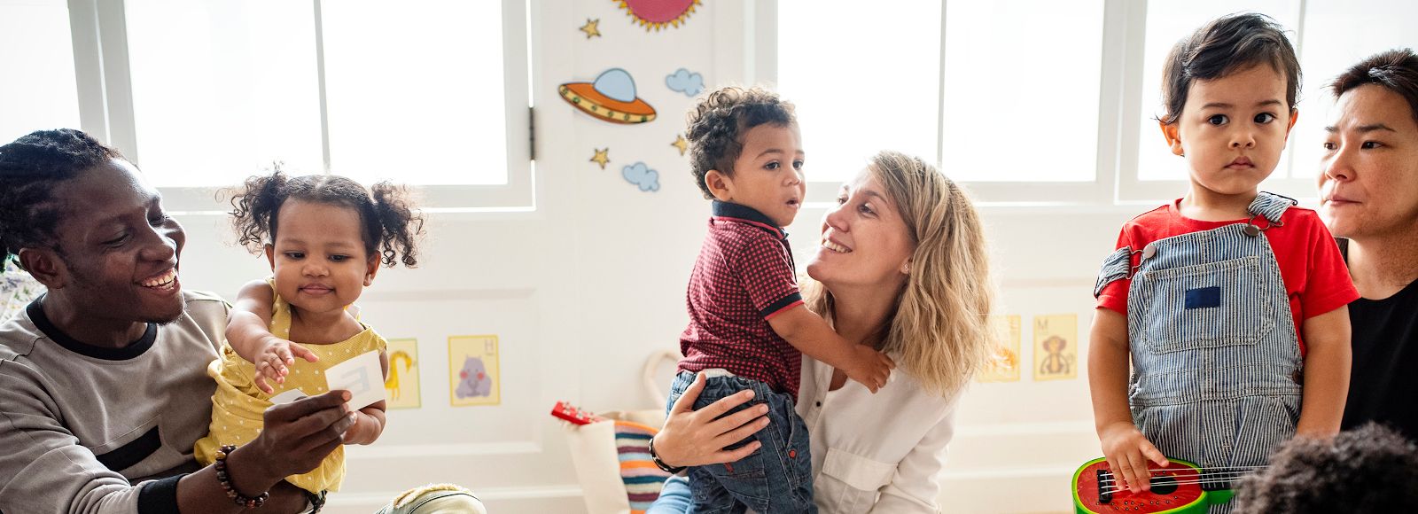  Children play in a playgroup with their parents. The group is multicultural.